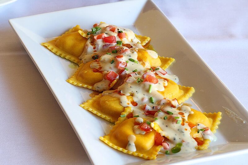 Ravioli entree topped with saffron-garlic cream