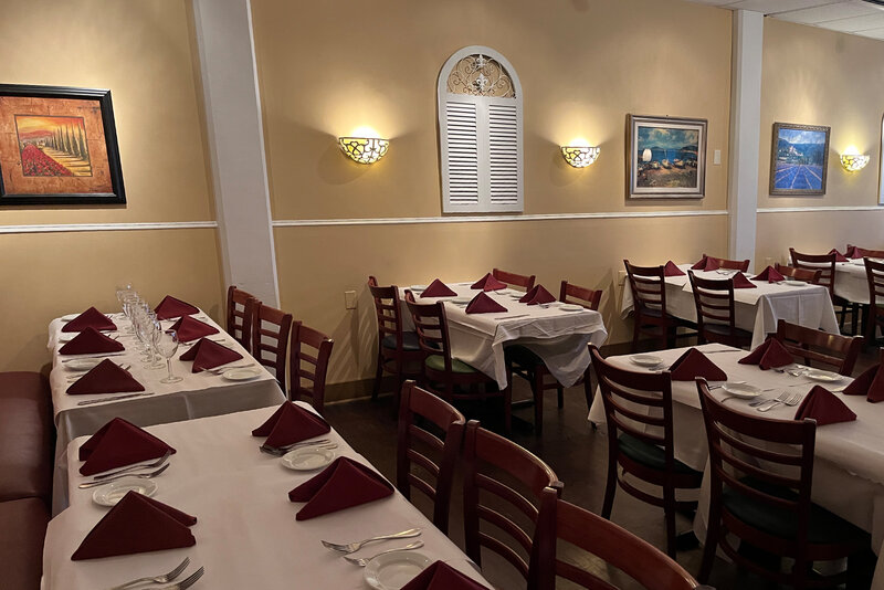 View of dining room with many set tables