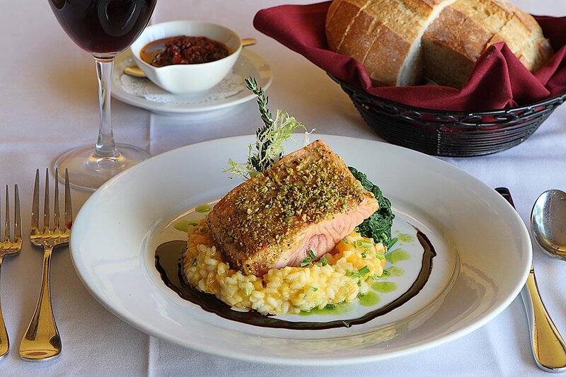 Salmon entree on top of risotto