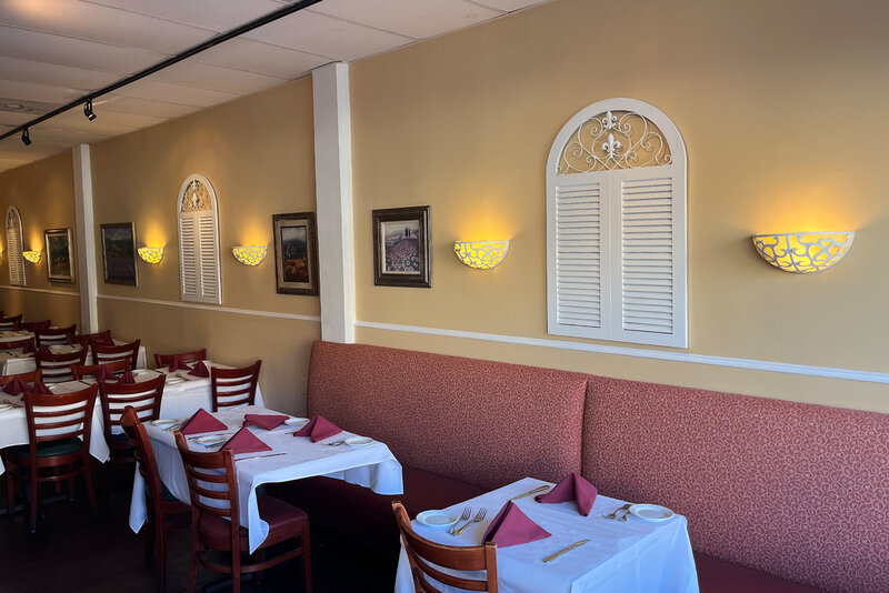 Dining room with view of set tables and booth seating