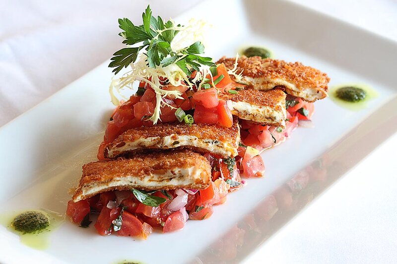 Fried mozzarella on top of bed of diced tomatoes