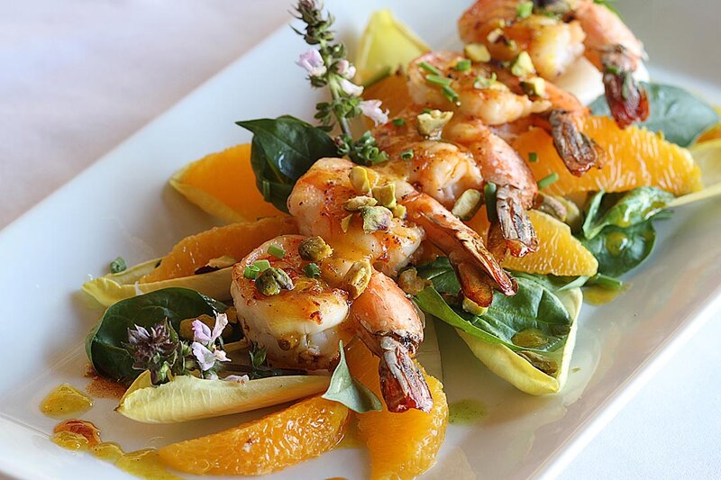 Orange slices and arugula topped with shrimp